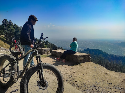 Mountain bikes on a Gulmarg valley trail overlooking alpine meadows