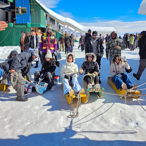 Traditional wooden sledging across Gulmarg meadows